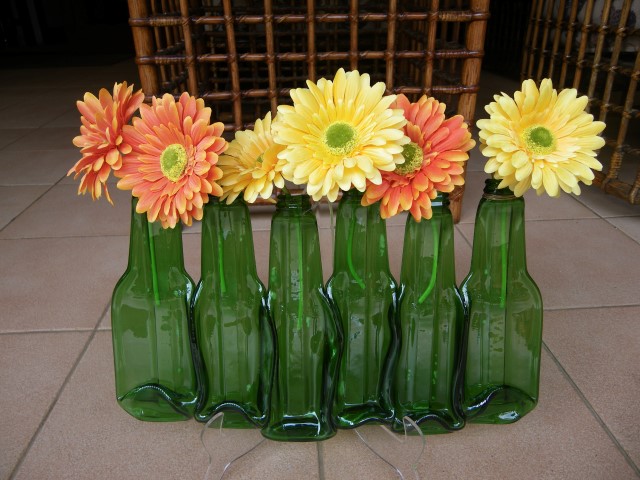 So many bottles hanging on the wall .... recycled glass bottle vases